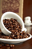 Close-up of coffee beans in cup and plate