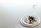 Sepia noodles and zucchini with lobster and wine glass, copy space