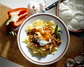 Farfalle with meat sauce and yogurt on plate