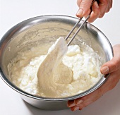 Egg whites being raised with batter in bowl