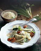 Ravioli with cherry tomatoes on plate