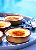 Crema catalana garnished with saffron in bowls on plate
