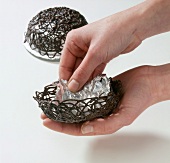 Aluminium foil being separated from chocolate basket