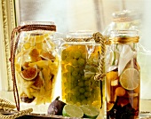 Preserved fruit with alcohol in glass jar tied up with plastic and rope