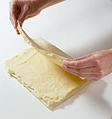 Dough being folded in baking paper