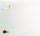 Saffron, halved lemon and flask filled half with water on white background, copy space