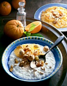 Bowl of rice pudding with oranges and dates