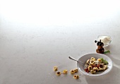 Plate with tortellini alla bolognese on white background, copy space