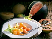 Various fruits in passion fruit sauce in serving dish