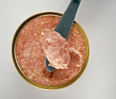Homemade sausage with piece on spatula, overhead view