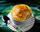 Close-up of cheese and walnut souffle in a souffle dish