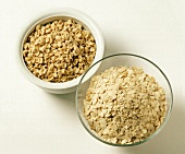 Close-up of two bowls with oat bran and oat bran flakes