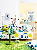 Living room with circle pattern white sofa, dining room in background