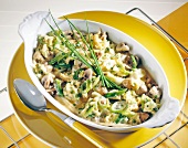 Close-up of egg with spring onions, mushrooms, cheese and chives in bowl