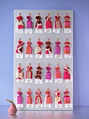Advent calendar with small colourful bags hanging on wooden board