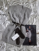 Sleeveless knitted dress with V-neck and belt on silver foil