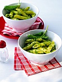 Penne with walnut and spinach pesto in bowls