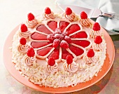 Close-up of butter cream cake with raspberries on plate