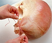Stuffed pig's stomach tied with kitchen string