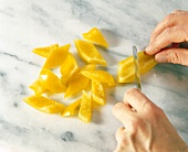 Close-up of yellow bell pepper cut with knife
