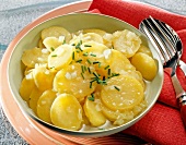 Swabian potato salad with onion and chives in bowl