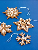 Gingerbread in different shapes with powdered sugar on blue background