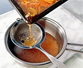 Preparation of sauce by sieving for Kassel Rippenspeer