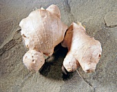 Close-up of ginger on stone, overhead view