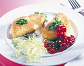 Baked Camembert with cranberries and herbs on plate