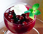 Close-up of raspberry and cherry compote with vanilla sauce in bowl