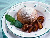 Sweet plum pie with plum compote and powdered sugar on plate