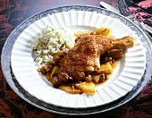 Chicken leg with rice and pineapple on plate