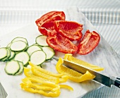Peppers and zucchini slices on chopping board