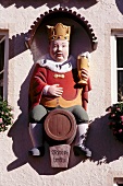 Guild sign of king sitting on a beer keg at brewery in Bavaria