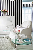 Striped wallpaper, white armchair, glass coffee table, side table and wardrobe