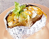 Baked potato with meat dip on plate