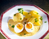 Classical mustard sauce with boiled eggs and potatoes on plate
