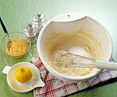 Whisk beat with other ingredients on table for making mayonnaise