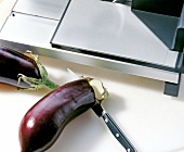 Close-up of eggplant being cut with knife