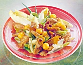 Close-up of chicken salad with papaya, chicory, spring onions and mango chutney on plate