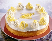 Close-up of lemon cake with cream and lemon zest in plate