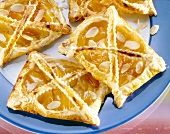 Close-up of apricot slices with marzipan and almonds on plate