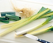 Close-up of leeks being cut into half