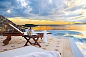 Sun lounger by the pool overlooking the Mediterranean island of Crete