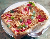 Rhubarb pudding with banana garnished with mint leaves in serving dish