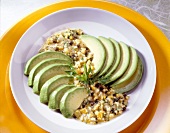 Slices of avocado with chopped egg and vinaigrette