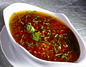 Vinaigrette with tomatoes and basil in bowl