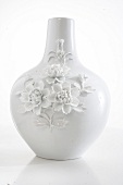 White porcelain vase with floral decoration on white background