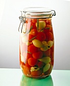 Canned cherry tomatoes and shallots in glass jar