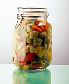 Canned cauliflower and peppers in glass jar